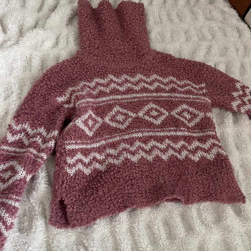 Teddy pink turtleneck sweater.